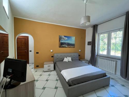 a bedroom with a bed and a flat screen tv at Casa Impagliazzo in Ischia