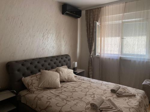 1 dormitorio con cama y ventana en Apartman Posejdon Deluxe en Vrnjačka Banja