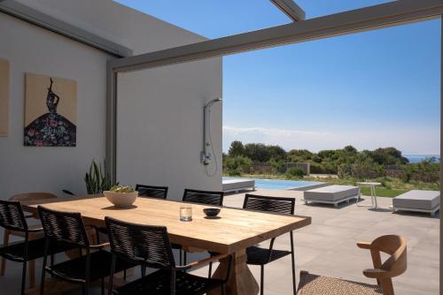 a dining room with a table and chairs and a pool at Margaret Villa - Pool, Heated Spa Whirlpool & BBQ, By ThinkVilla in Angeliana
