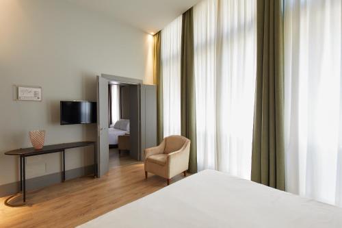מיטה או מיטות בחדר ב-Hotel Dei Dragomanni