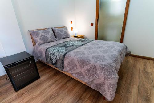a bedroom with a bed and a large mirror at La Bebe 2 Beds in Hunedoara