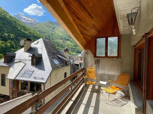 a balcony with chairs and a view of mountains at Les Moutons de Cauterets - garage privé in Cauterets