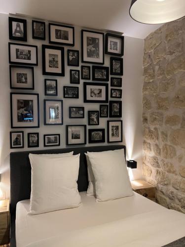 a bedroom with a wall of pictures above a bed at Loft Jaures in Paris