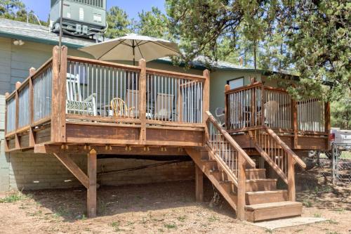 a large deck with chairs and an umbrella at Pine Cabin in Pine