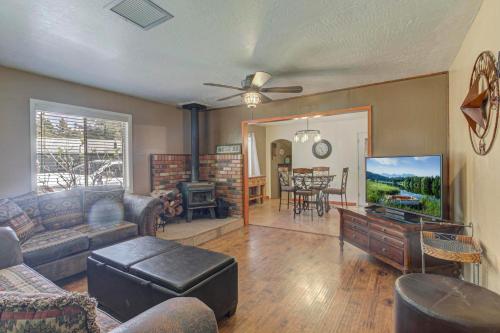 a living room with a couch and a flat screen tv at Pine Cabin in Pine