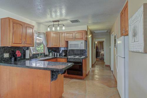 a kitchen with wooden cabinets and a black counter top at Pine Cabin in Pine