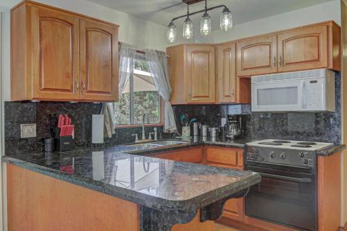a kitchen with wooden cabinets and a granite counter top at Pine Cabin in Pine