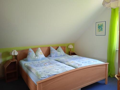 a bedroom with a bed with blue sheets and pillows at Ferienwohnung kaub in Immerath