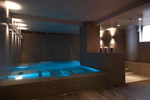 a bathroom with a tub with blue lights in it at Ego Hotel in Ancona