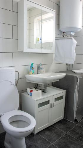 a bathroom with a white toilet and a sink at Apartman Filimena in Kruševac