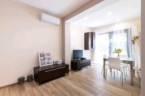 a living room with a table and a dining room at Casa Aurora in Santa Luria