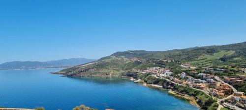 an aerial view of a village on a hill next to the water at La villetta TRE PALME in Valledoria