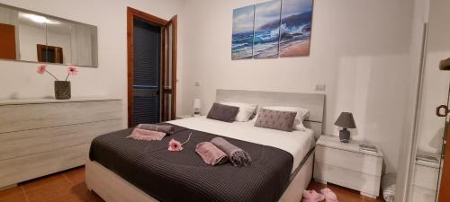 a bedroom with a large bed with two pillows on it at La villetta TRE PALME in Valledoria
