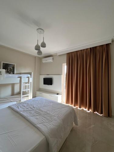 a bedroom with a bed and a large window at Hotel Mare in Ksamil