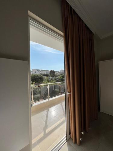 a room with a large window with a view at Hotel Mare in Ksamil