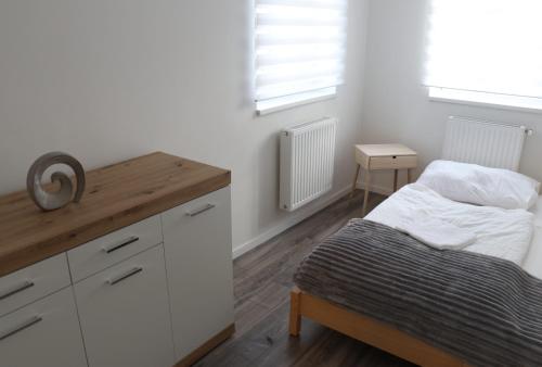 a bedroom with a bed and a wooden counter top at FlóDá Ház in Sopron