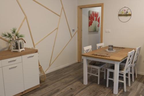 a kitchen and dining room with a table and chairs at FlóDá Ház in Sopron