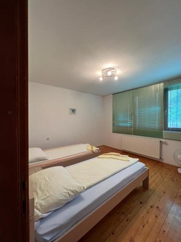 a bedroom with two beds and a window at Villa ''M&A'' in Sarajevo