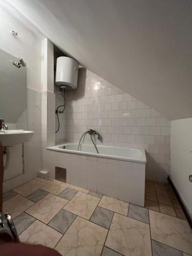 a bathroom with a bath tub and a sink at Villa ''M&A'' in Sarajevo