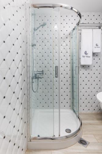 a shower with a glass door in a bathroom at Ilis Villas in Nikiti
