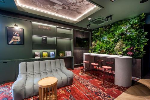 a living room with a couch and a large plant at Mercure Bialystok in Białystok