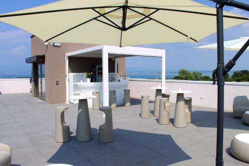 a large yellow umbrella sitting on top of a patio at Hotel Cristal in Sirmione