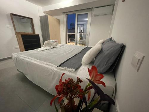 a large bed in a room with a window at Serene Napa Suite in Ayia Napa
