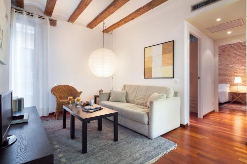 
a living room filled with furniture and a fireplace at Inside Barcelona Apartments Esparteria in Barcelona
