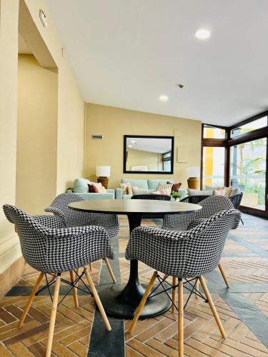 a room with a table and chairs and a couch at Soho Boutique Puerto in El Puerto de Santa María