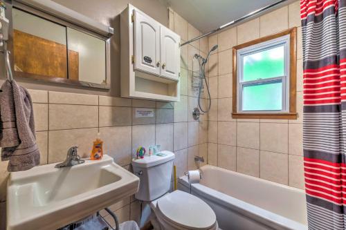a bathroom with a toilet and a sink and a tub at Cozy Kentucky Cabin with Sunroom, Yard and Views! in Cub Run