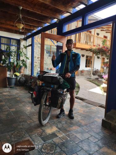 a man sitting on a motorcycle in front of a building at Casona Mollepata in Mollepata