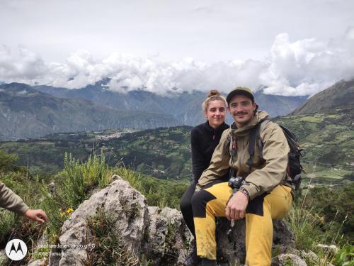 a man and a woman sitting on top of a mountain at Casona Mollepata in Mollepata