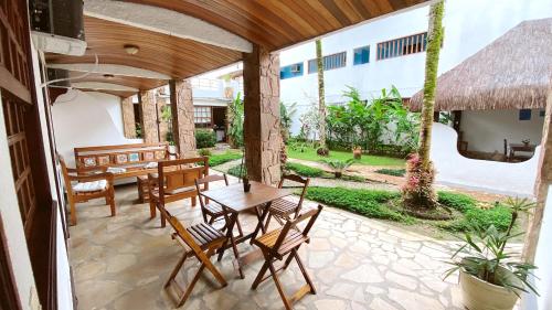 a patio with a table and chairs and a table at HOTELARE Hotel Brunello in Paraty