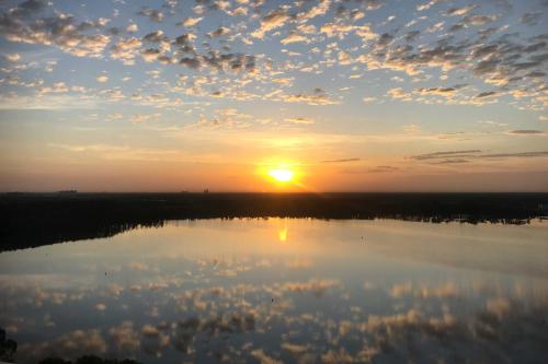 a sunset over a large body of water at Luxury Condo with Huge Private Balcony on Lake Bryan in Orlando