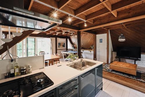 a kitchen with a sink and a stove at LOGIN OKlNAWA -counrty- in Onna