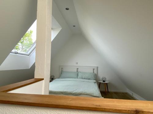 a bedroom with a bed in a attic at Mansarde “Sabine“ in Montabaur