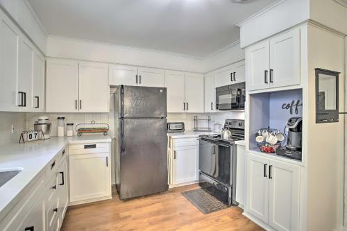 a kitchen with white cabinets and a stainless steel refrigerator at 1 Mi to Main St Brenham Retreat with Game Room in Brenham