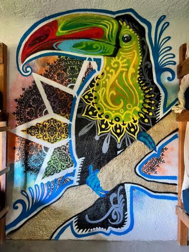 a wall with a painting of a peacock on it at Apartment close to the town UTOPIA in Holbox Island