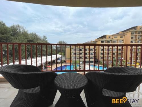 a balcony with chairs and a view of a pool at Gold Coast Morib Themepark View Studio in Banting