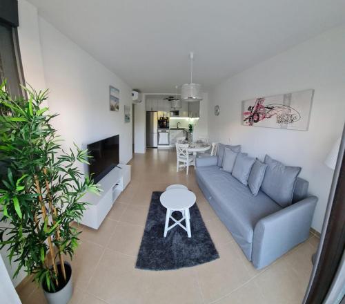 a living room with a couch and a table at Casa Soñada - Dream House in Garrucha