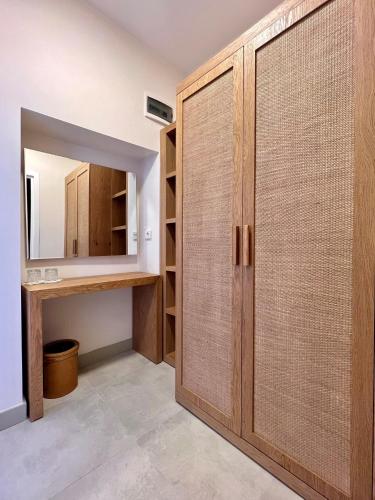 a bathroom with a wooden closet and a mirror at Lavinya Otel in Golturkbuku