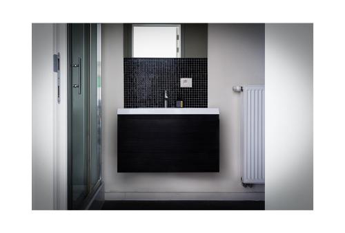 a bathroom with a sink and a mirror at Central Perk Apartments-Antwerp in Antwerp