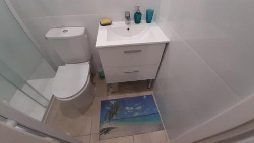 a bathroom with a white toilet and a sink at HAPPY HoMe For You in Lunel