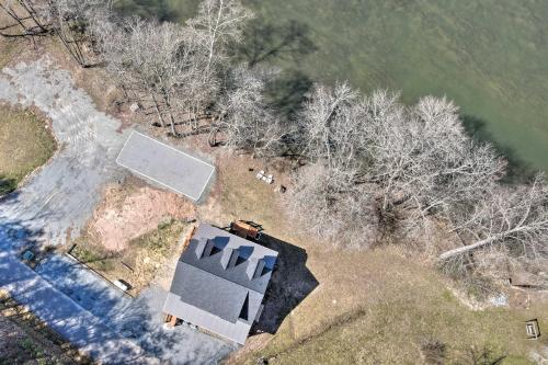 an overhead view of a house and a tennis court at Charming Murphy House with Deck and River Views! in Murphy