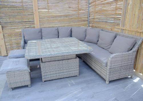 a wicker couch and table on a patio at Amazing Villa With Large Private Swimming Pool in Tangier