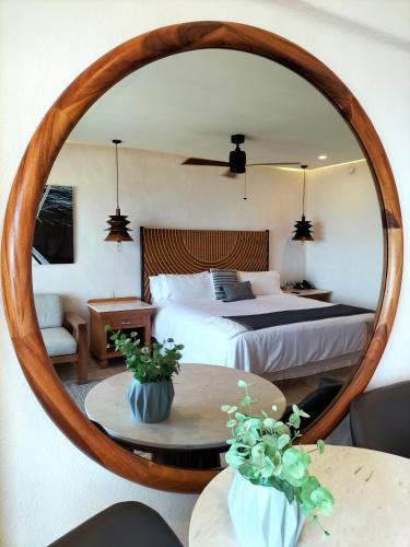 a bedroom with a bed and a large mirror at Fiesta Americana Puerto Vallarta All Inclusive & Spa in Puerto Vallarta