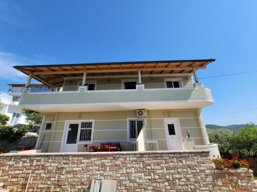 a house on top of a brick wall at Spahiu Guesthouse in Ksamil
