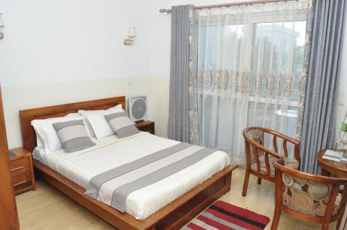 Ένα ή περισσότερα κρεβάτια σε δωμάτιο στο Hôtel Sky blue Mada