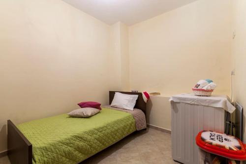a small bedroom with a bed and a heater at Stella in Panasós
