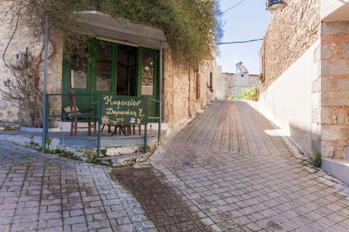 an alley with a bench in front of a building at Stella in Panasós